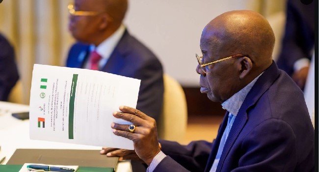 President Bola Tinubu and presidential aide Bayo Onanuga during Tinubu's working vacation abroad.
