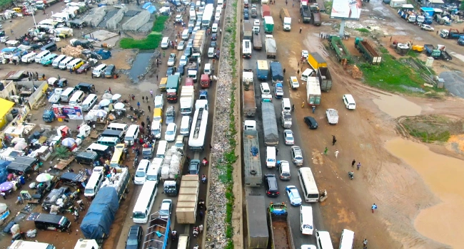 Severe traffic gridlock on the Lagos-Ibadan Expressway near Kara Bridge as road repairs and a fallen container-laden trailer disrupt movement.