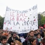 Protesters march during a demonstration in Paris, France, on October 6, 2026, amid nationwide protests over rising living costs and learning conditions.