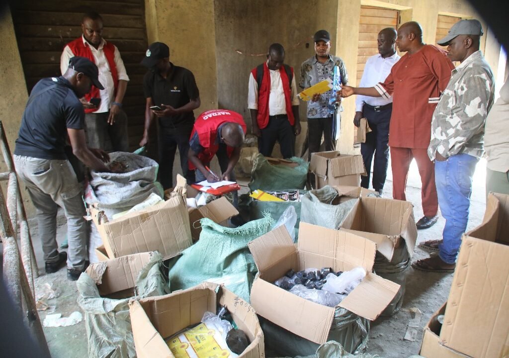 NAFDAC enforcement officers uncover suspected counterfeit drinks and packaging materials at a facility in Lagos Trade Fair Complex.
