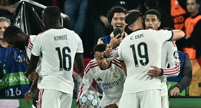 Real Madrid players celebrate Antonio Rudiger's late winning goal in their dramatic 4-3 Champions League comeback against Roma at the Stadio Olimpico on October 14, 2026.