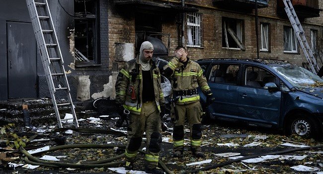 Rescuers search a damaged five-storey residential building after a Russian strike in Ukraine.