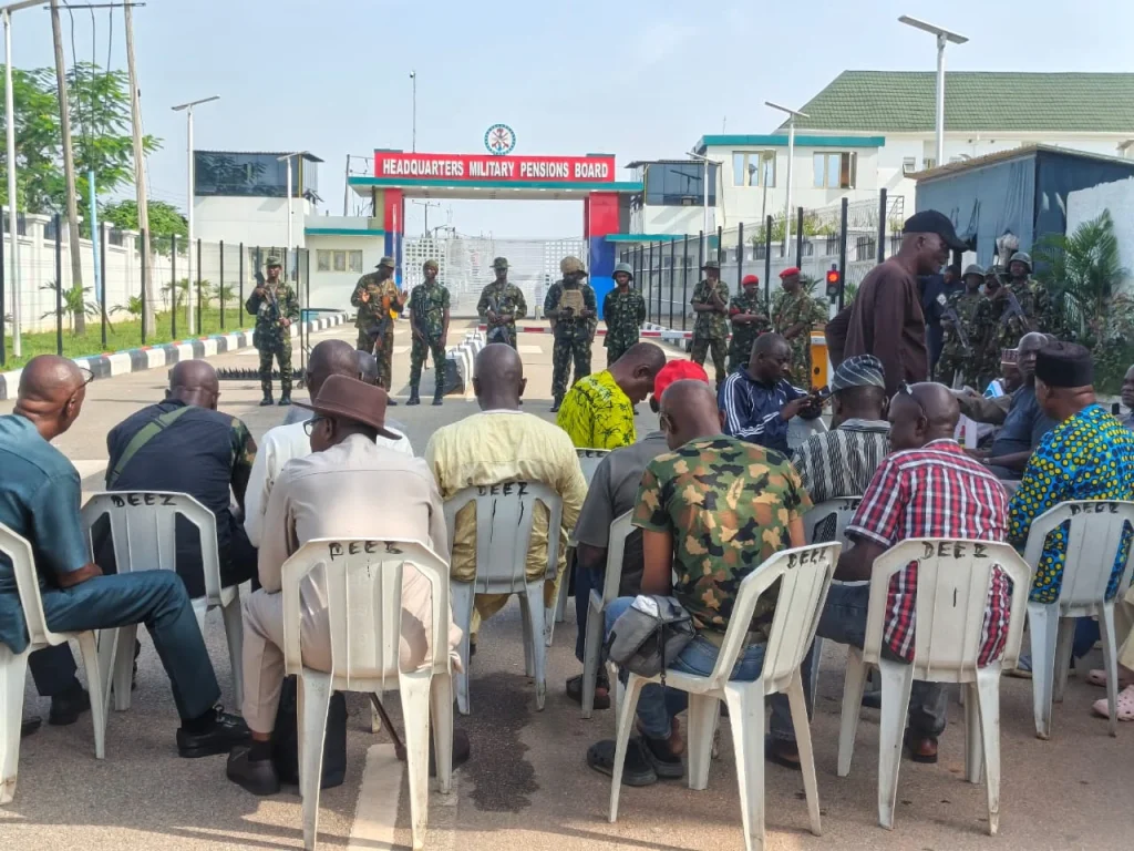 Military retirees barricade the entrance to the Military Pensions Board office in Dutse Alhaji, Abuja, during a protest over pension adjustments on October 13, 2026.