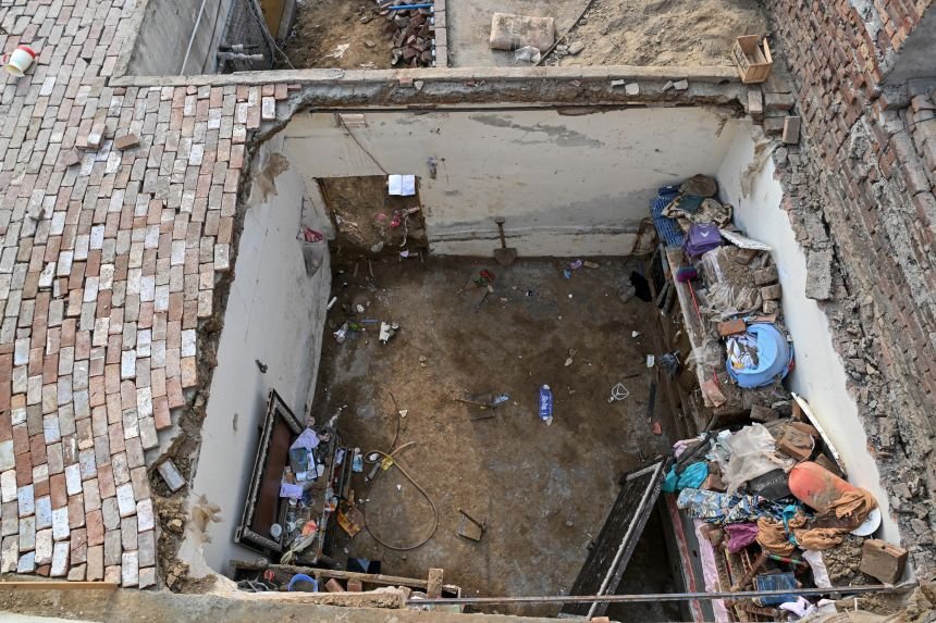 Rescue workers and residents search through debris after a school roof collapsed in Peshawar, Pakistan, on October 15, 2026.