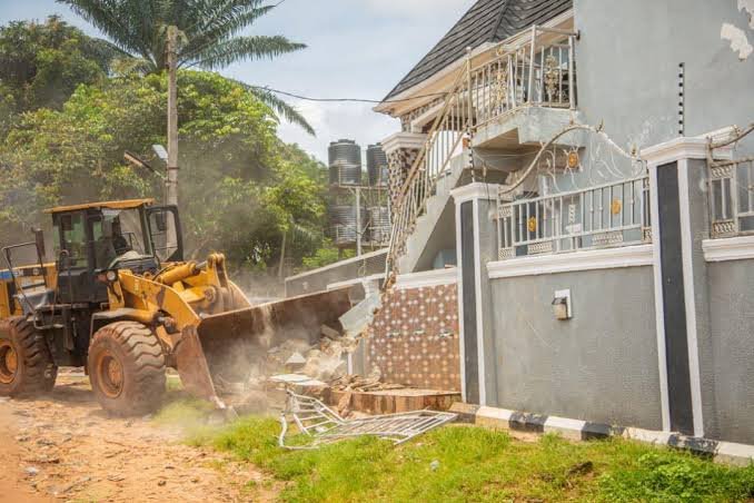Edo State security officials demolish a building in Uromi allegedly linked to suspected ritual activities during a crackdown on crime.