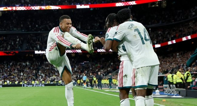 Real Madrid forward Kylian Mbappe celebrates with teammates after scoring during the 4-1 La Liga victory over Sevilla at the Santiago Bernabeu on October 18, 2026.