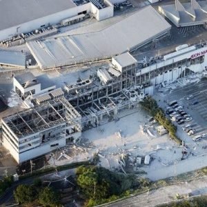 Emergency responders gather outside the damaged Aeon Mall in Kumamoto after a powerful earthquake caused part of the building to collapse.
