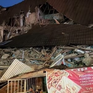 Collapsed building in Wuse Zone 4, Abuja, as emergency responders conduct search and rescue operations.