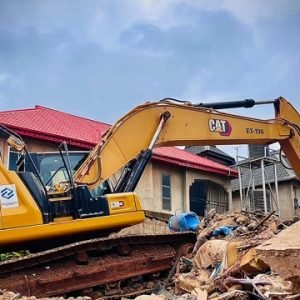 Rescue workers search the rubble after a two-storey building sank into the ground in Ajuwon, Ogun State, killing three people and rescuing 12 others.