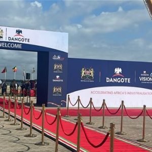 Dangote East Africa Petroleum Refinery groundbreaking ceremony in Lamu, Kenya, with tractors and guests at the project site.