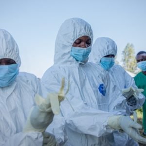 Ebola response volunteers in protective equipment prepare to recover a suspected Ebola victim in Bunia, DR Congo.