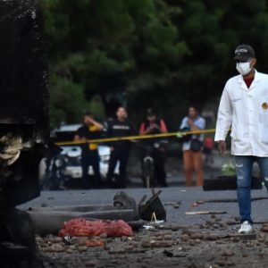 Police inspect the wreckage of an explosives-laden truck after a bombing near a police station in Cucuta, Colombia, ahead of the presidential inauguration.
