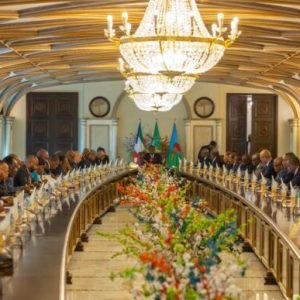 Equatorial Guinea government cabinet meeting room with officials discussing national policy and economic performance review in Malabo.