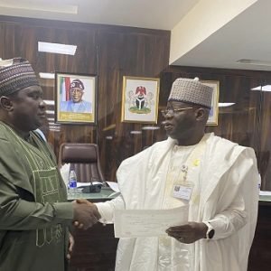 INEC officials presenting Certificates of Return to winners of by-elections held across six Nigerian states during a formal ceremony.