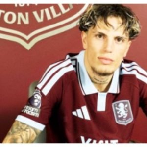 Alejandro Garnacho poses in an Aston Villa home shirt after completing his season-long loan move from Chelsea to Villa Park.