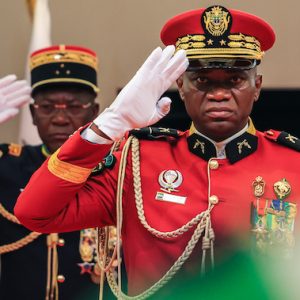 Gabon's new strongman General Brice Oligui Nguema (R) salutes as he is inaugurated as Gabon's interim President, in Libreville on September 4, 2023. - Gabon's coup leader vowed after being sworn in as interim president on September 4, 2023 to restore civilian rule through "free, transparent and credible elections" after a transition and amnesty prisoners of conscience. (Photo by - / AFP) / ALTERNATE CROP - ALTERNATE CROP