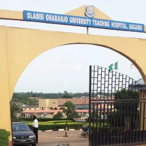 Resident doctors protesting at Olabisi Onabanjo University Teaching Hospital entrance in Sagamu during a warning strike announcement.