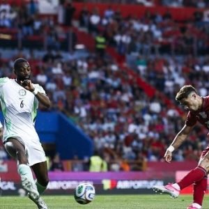 Nigeria Super Eagles and Portugal players contesting an international friendly match in Leiria, with Portugal scoring a late winning goal.