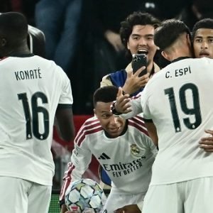 Real Madrid players celebrate Antonio Rudiger's late winning goal in their dramatic 4-3 Champions League comeback against Roma at the Stadio Olimpico on October 14, 2026.