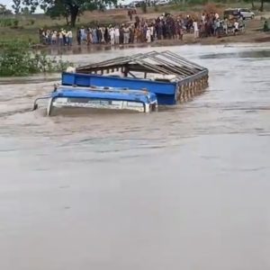 Floodwater covering the collapsed Moro Bridge in Kwara State with stranded vehicles and commuters waiting for rescue.