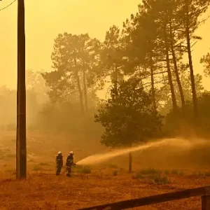 Firefighters battle a massive wildfire near Bordeaux as thick smoke engulfs forests during record blazes in France.