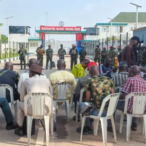 Military retirees barricade the entrance to the Military Pensions Board office in Dutse Alhaji, Abuja, during a protest over pension adjustments on October 13, 2026.