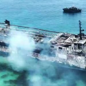 Burnt ferry after a fire off Palawan in the Philippines, with rescue efforts ongoing