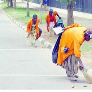 Street sweepers working along a roadside during sanitation exercise in Taraba State, Nigeria.
