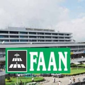 FAAN signage at Nigerian airport terminal with taxis lined up outside awaiting passengers and regulatory updates.