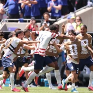 USA players celebrating a goal against Australia during their 2-0 World Cup 2026 victory in Seattle.