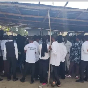 NSCDC operatives with rescued students after uncovering a suspected fake university operating from a residential apartment in Badagry, Lagos.