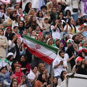 Iranian football supporters at a stadium during an international match, representing World Cup fan attendance concerns.