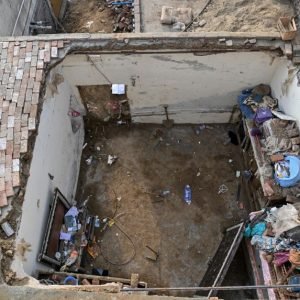 Rescue workers and residents search through debris after a school roof collapsed in Peshawar, Pakistan, on October 15, 2026.