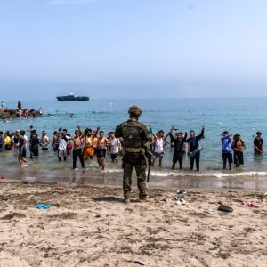 Migrants swimming from Morocco towards Spain's North African enclave of Ceuta during the mass border crossing.
