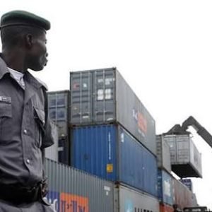 Nigeria Customs Service officials display seized military camouflage uniforms and illicit drugs intercepted from a luxury passenger bus in Ogun State.