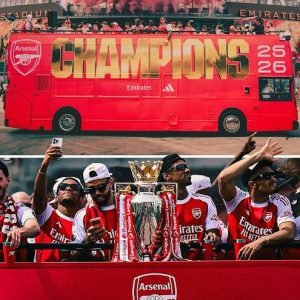Arsenal players and manager Mikel Arteta celebrate with the Premier League trophy during an open-top bus parade through north London as thousands of fans line the streets.