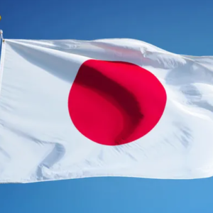 Japanese flag waving outside a government building as Japan tightens student visa and documentation requirements for foreign students.