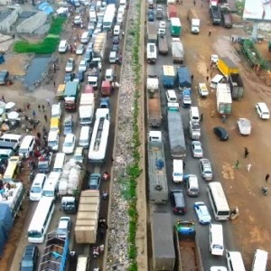 Severe traffic gridlock on the Lagos-Ibadan Expressway near Kara Bridge as road repairs and a fallen container-laden trailer disrupt movement.