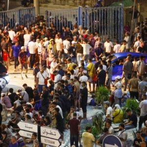 Migrants gather near the border fence between Morocco and Spain's Ceuta enclave during an overnight mass crossing.