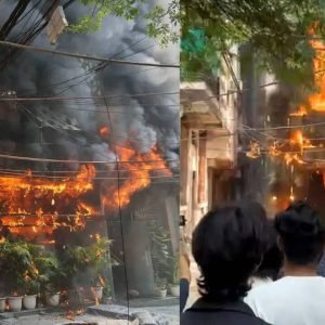 Firefighters and emergency responders at the scene of a deadly hotel fire in New Delhi's Malviya Nagar neighbourhood.