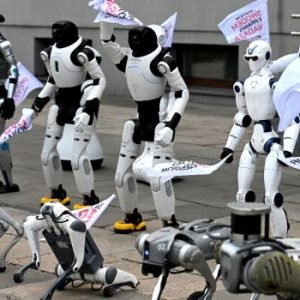 Humanoid and quadruped robots march through Warsaw during a protest calling for stronger artificial intelligence regulation.